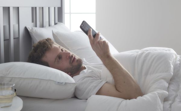Man in bed on smart phone